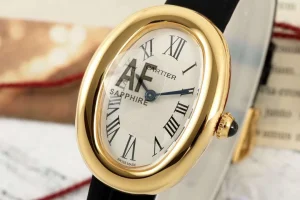 Cartier Baignoire Yellow Gold Oval Women’s Watch with White Dial, Roman Numerals, Black Leather Strap, and Sapphire Cabochon Crown